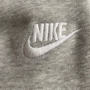 Two Nike sweatpants, both sized medium,one black and one gray.
